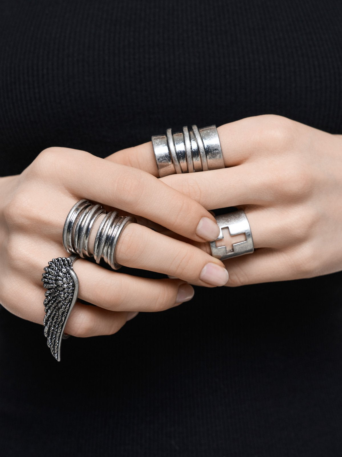 Set of 4 silver rings with wing and cross designs