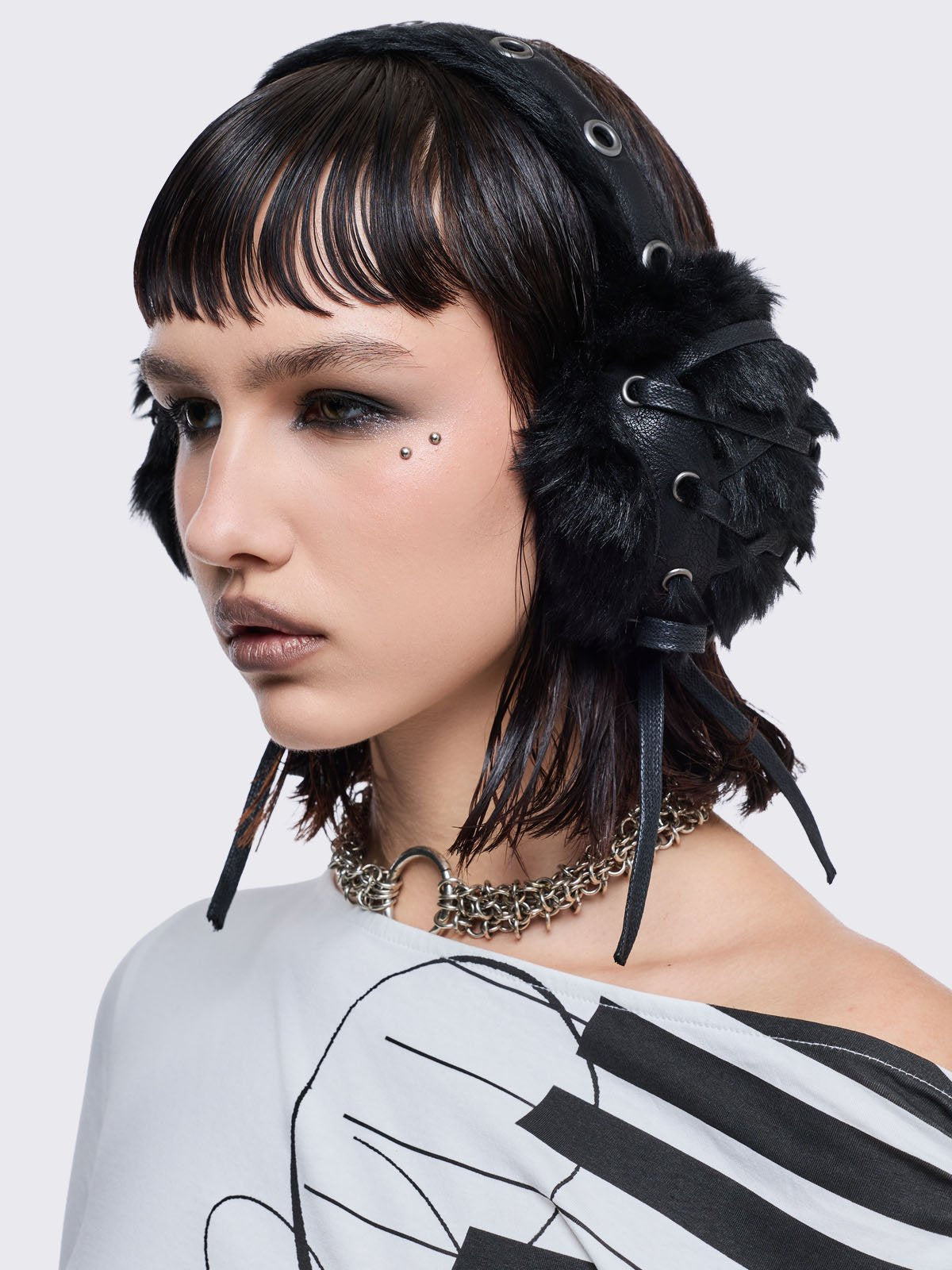 Black faux fur earmuffs and silver eyelet and lace up details.