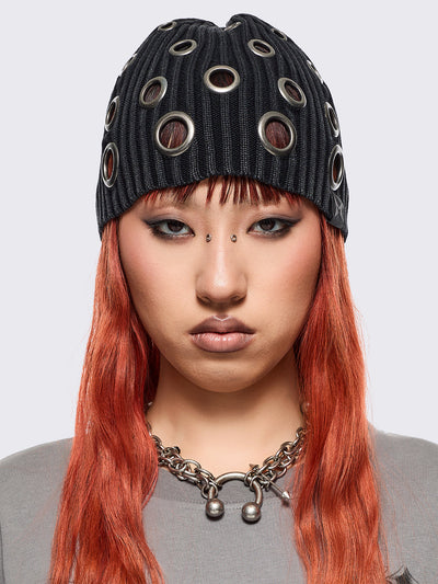 Black ribbed knit beanie with chunky silver eyelets.