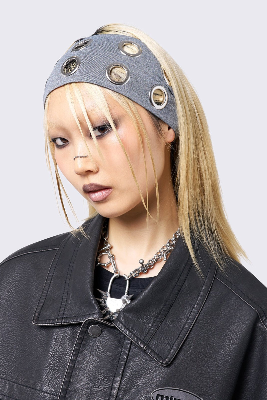 Grey headband with metallic hole details.