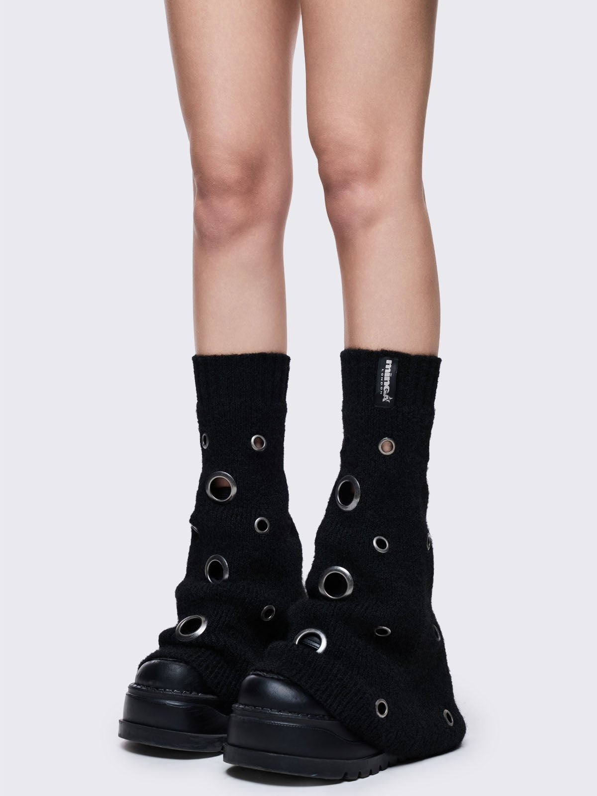 Black knitted flare leg warmers with chunky silver eyelets