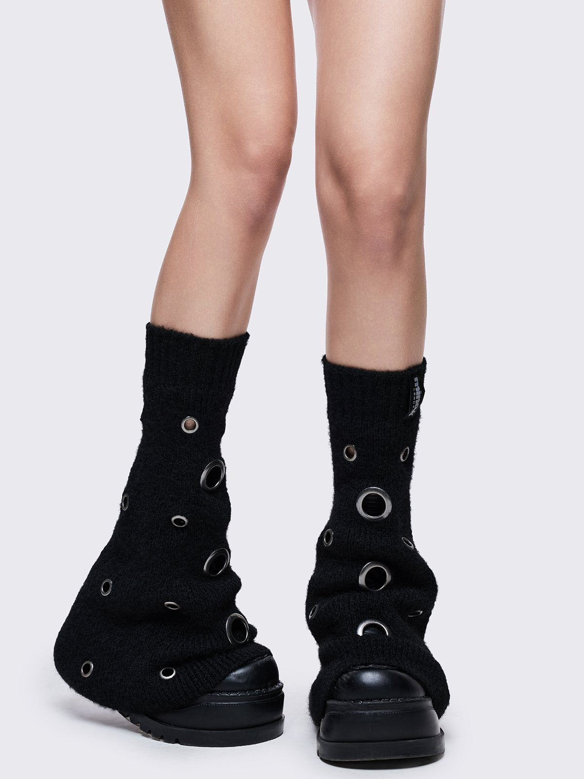 Black knitted flare leg warmers with chunky silver eyelets