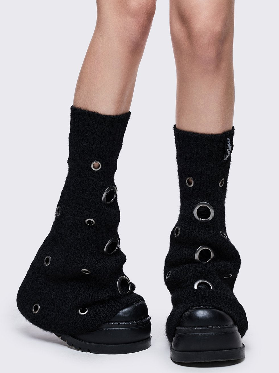 Black knitted flare leg warmers with chunky silver eyelets