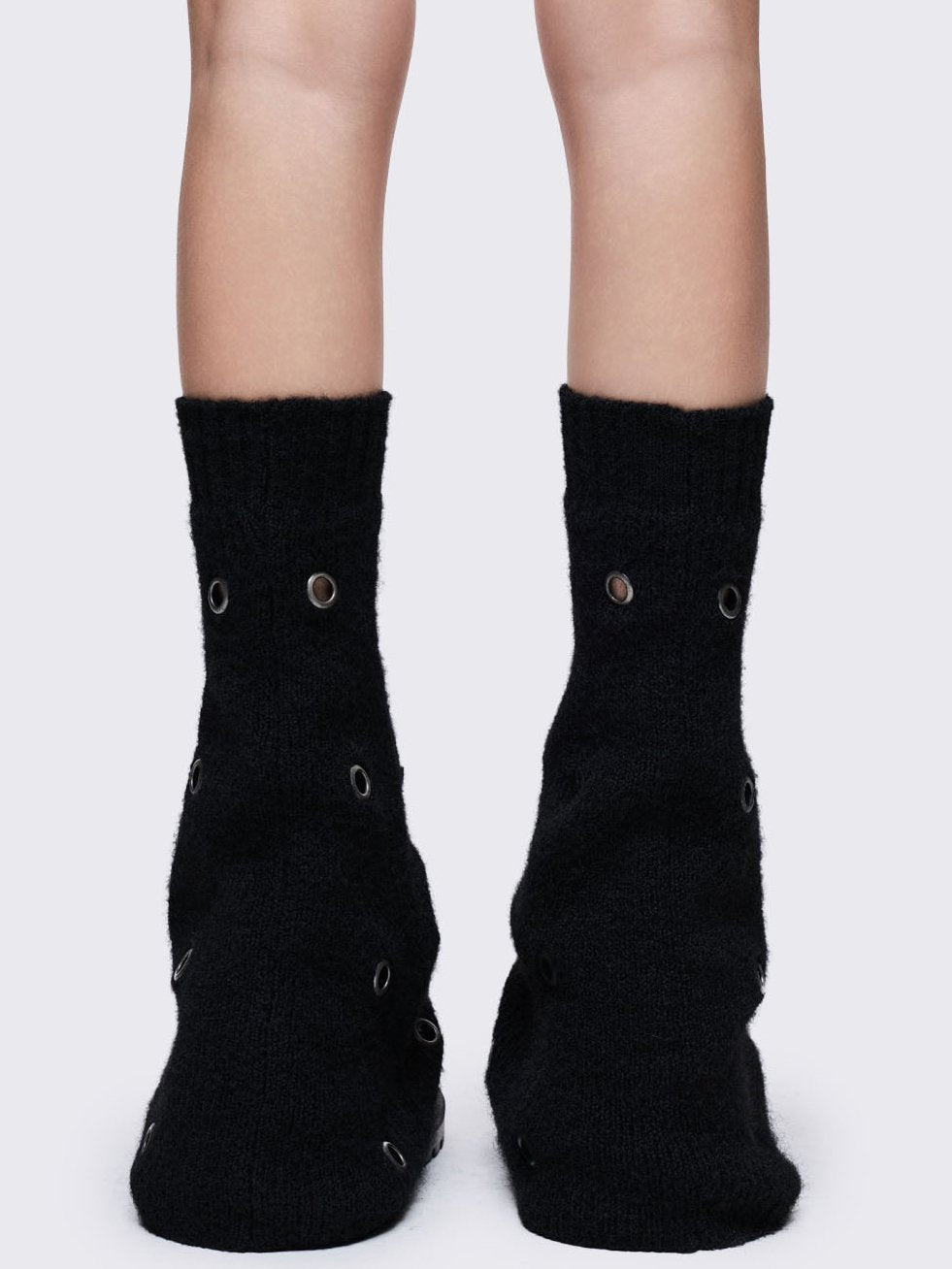 Black knitted flare leg warmers with chunky silver eyelets
