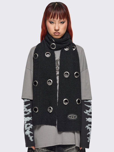 Black knitted scarf with chunky silver eyelets.