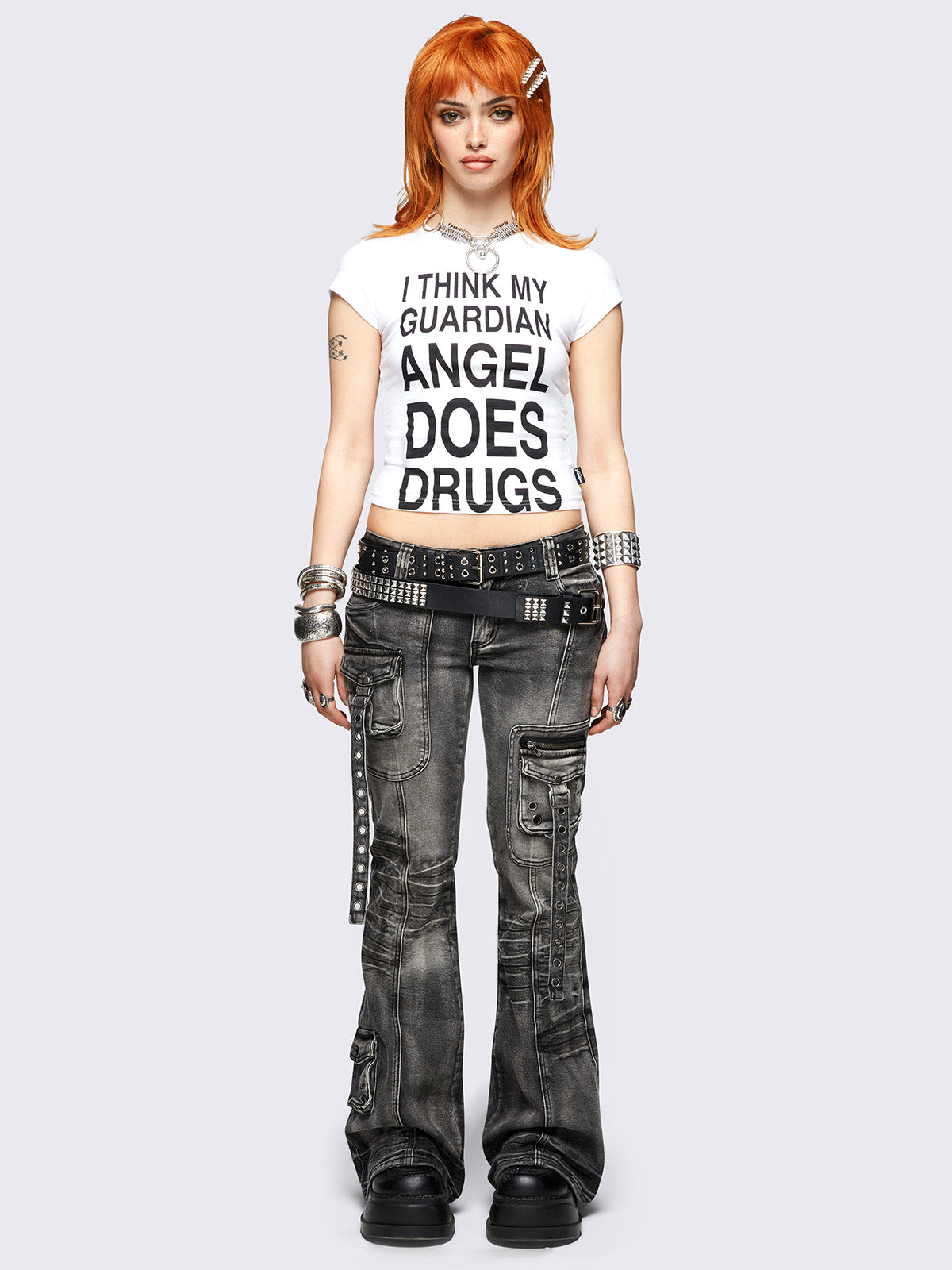 Black washed cargo flared jeans with utility pockets and straps.