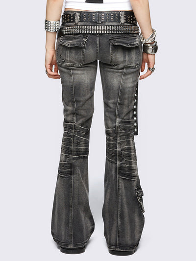 Black washed cargo flared jeans with utility pockets and straps.