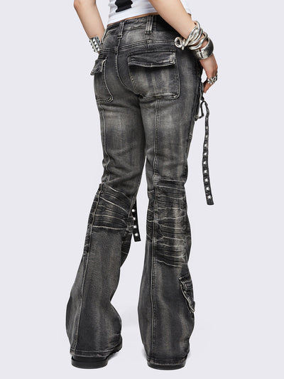 Black washed cargo flared jeans with utility pockets and straps.