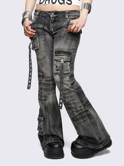 Black washed cargo flared jeans with utility pockets and straps.