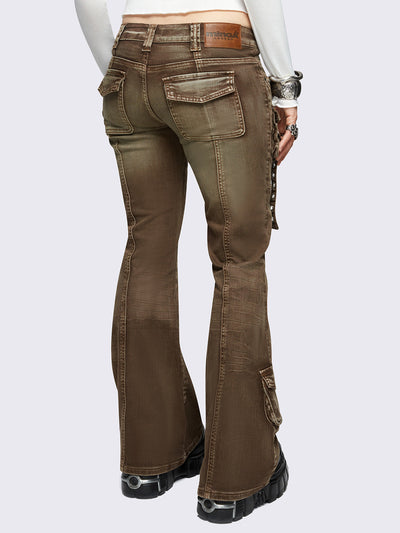Brown washed cargo flared jeans with utility pockets and straps.