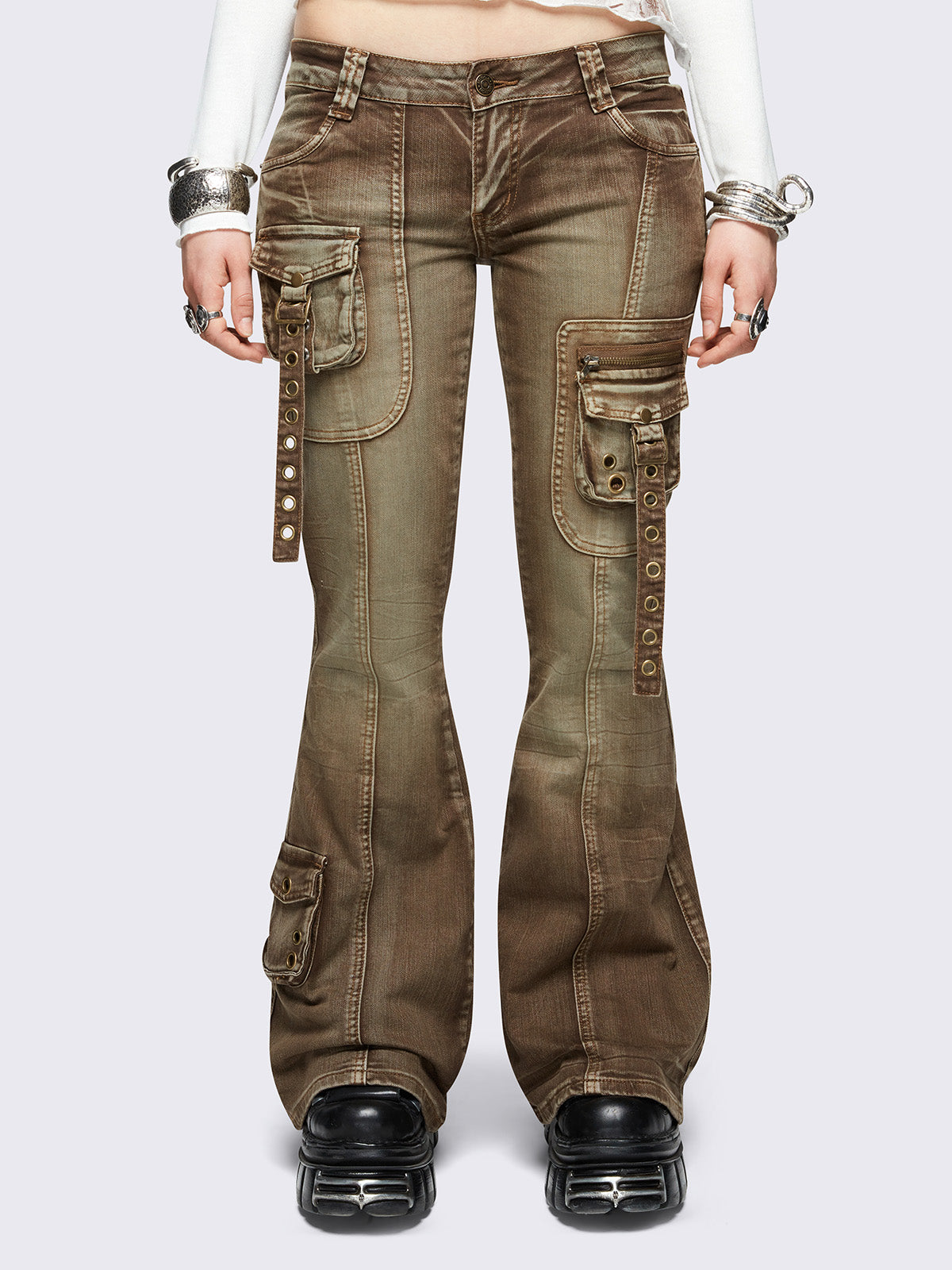 Brown washed cargo flared jeans with utility pockets and straps.