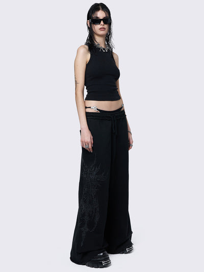 Wide leg joggers in black with grunge graphic side print.