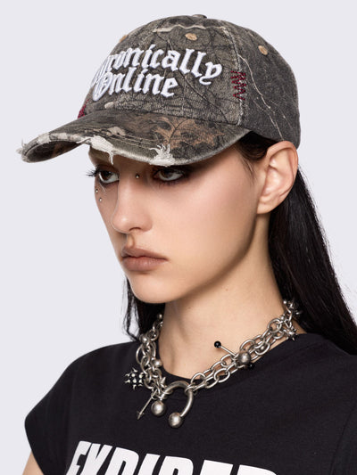 Forest tree como print denim baseball cap with "Chronically online" chunky embroidery and distressed details.