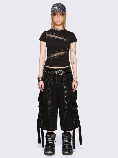 Black baby tee with diagonal fishnet cut-outs, eyelet and chain lace-up details, and short sleeves.