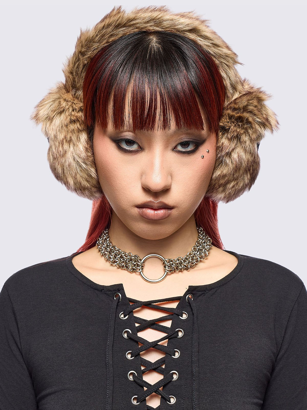 Faux fur earmuffs in beige and brown featuring stars embroidered patch in black.