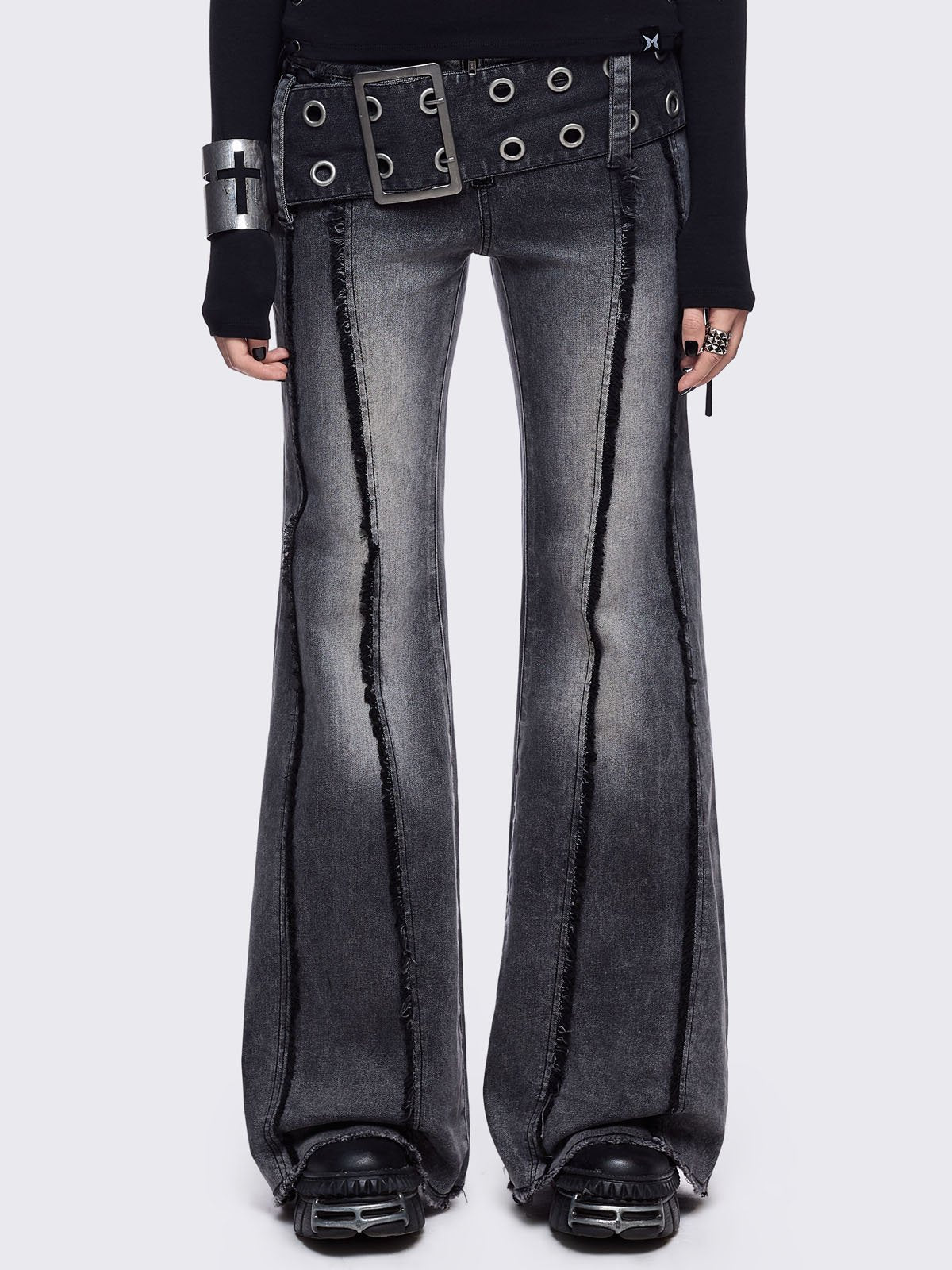 Grey flared jeans with light grey overdye featuring a chunky buckle belt and distressed seams details.