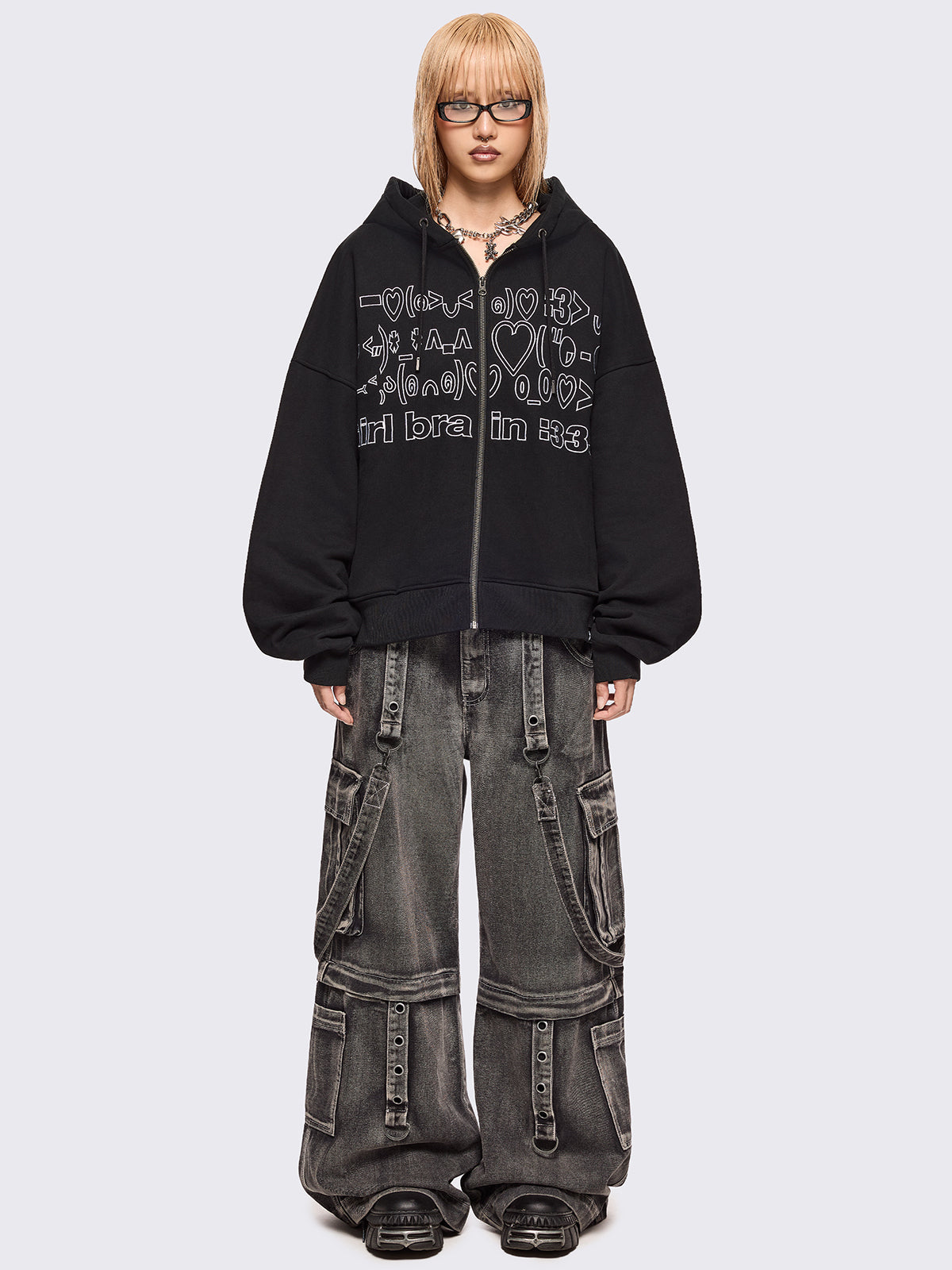 Black zip up hoodie jacket featuring a kaomoji ASCII-style embroidery in white.