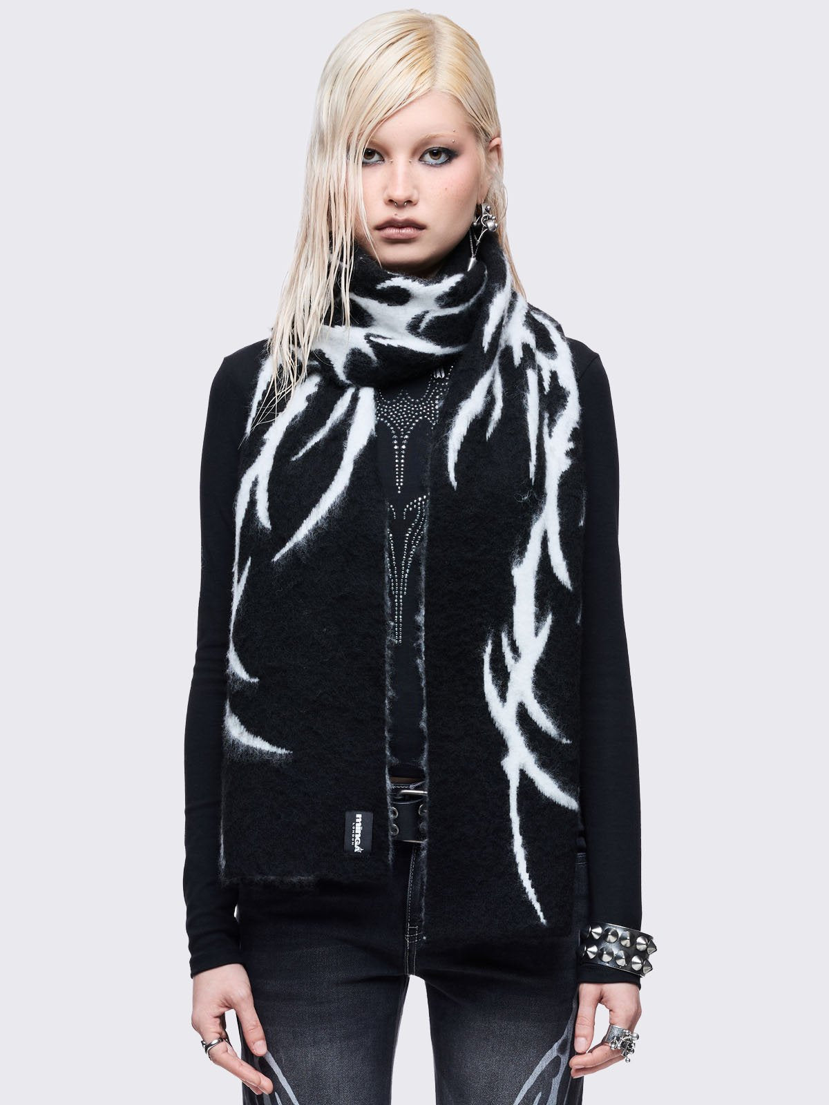 ong, chunky, and fluffy scarf featuring a high-contrast diffused tribal sigil pattern in black and grey