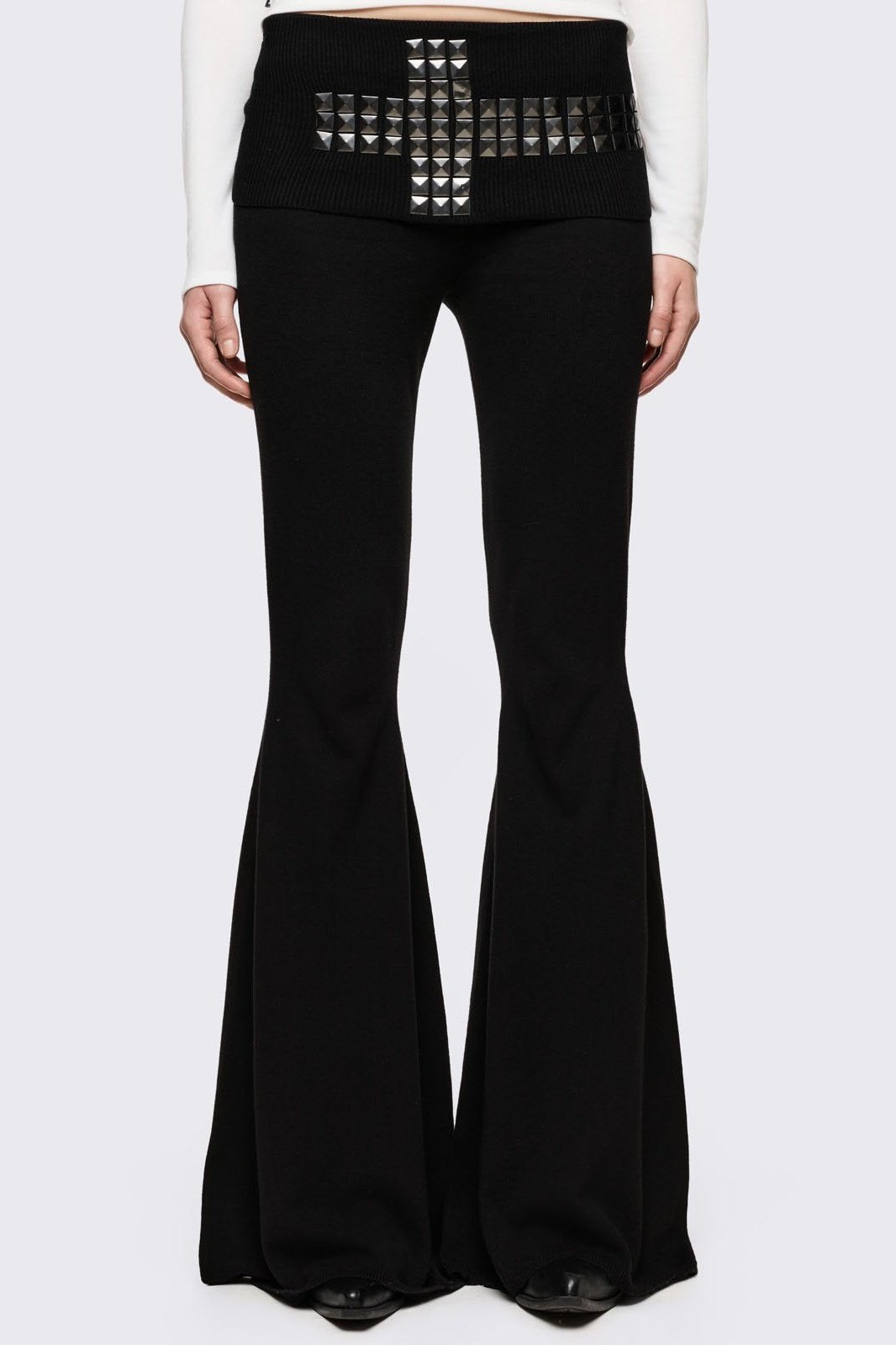 Black flare pants with folded ribbed waistband with studded cross