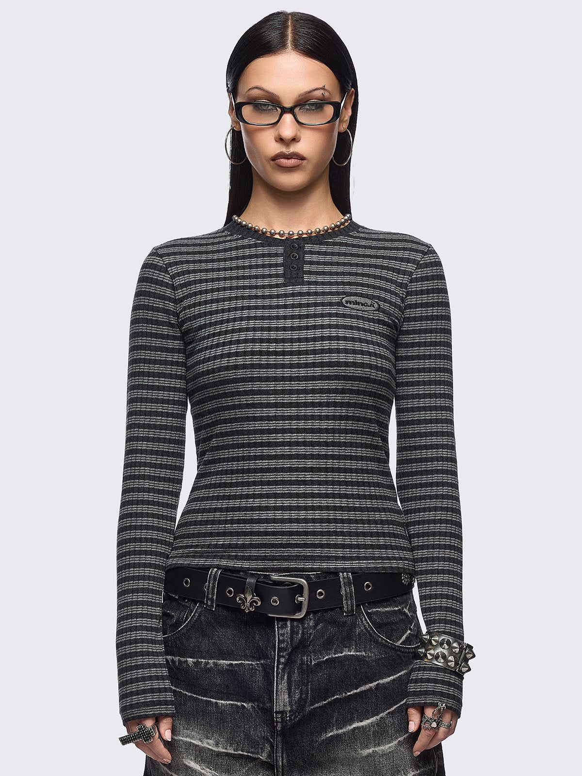 Black and grey striped ribbed long sleeve top featuring a half button placket.