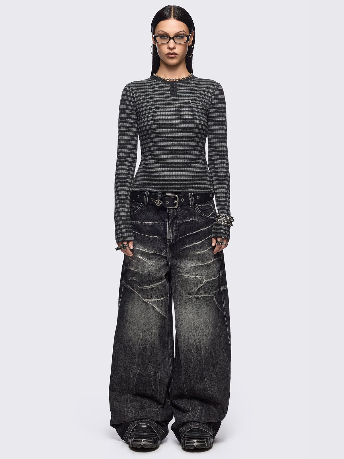 Black and grey striped ribbed long sleeve top featuring a half button placket.