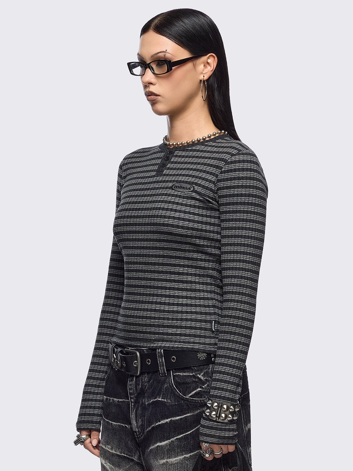 Black and grey striped ribbed long sleeve top featuring a half button placket.