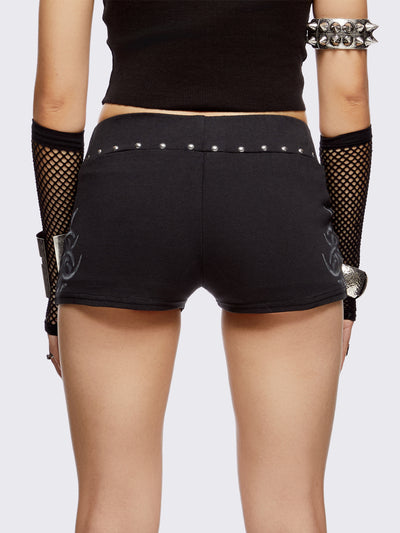 Black sweat micro shorts with silver studs in waistline and sigilism graphic print on sides. 