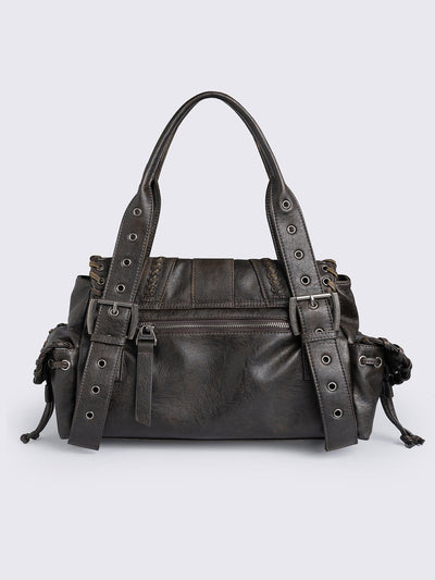 Brown faux leather shoulder bag featuring lace ups, eyelets, buckles and multiple pockets.