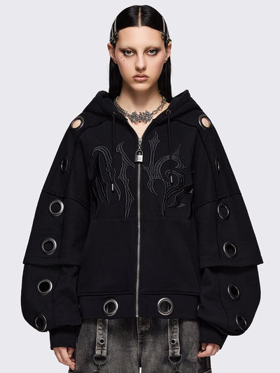 Black layered zip up hoodie, with chunky silver eyelets, raw edge seam details and Minga embroidery.
