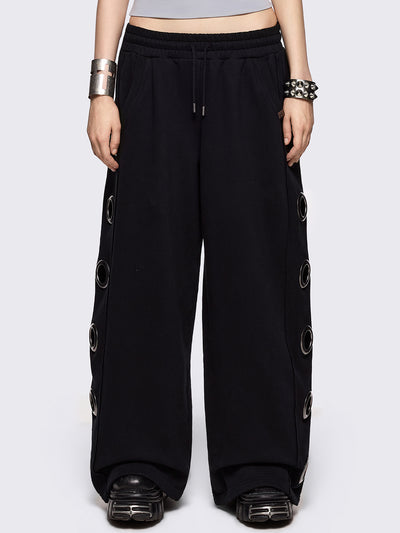 Black wide leg sweatpants with chunky silver eyelets.
