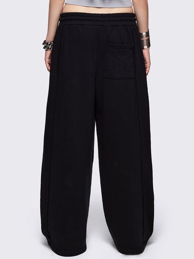 Black wide leg sweatpants with chunky silver eyelets.