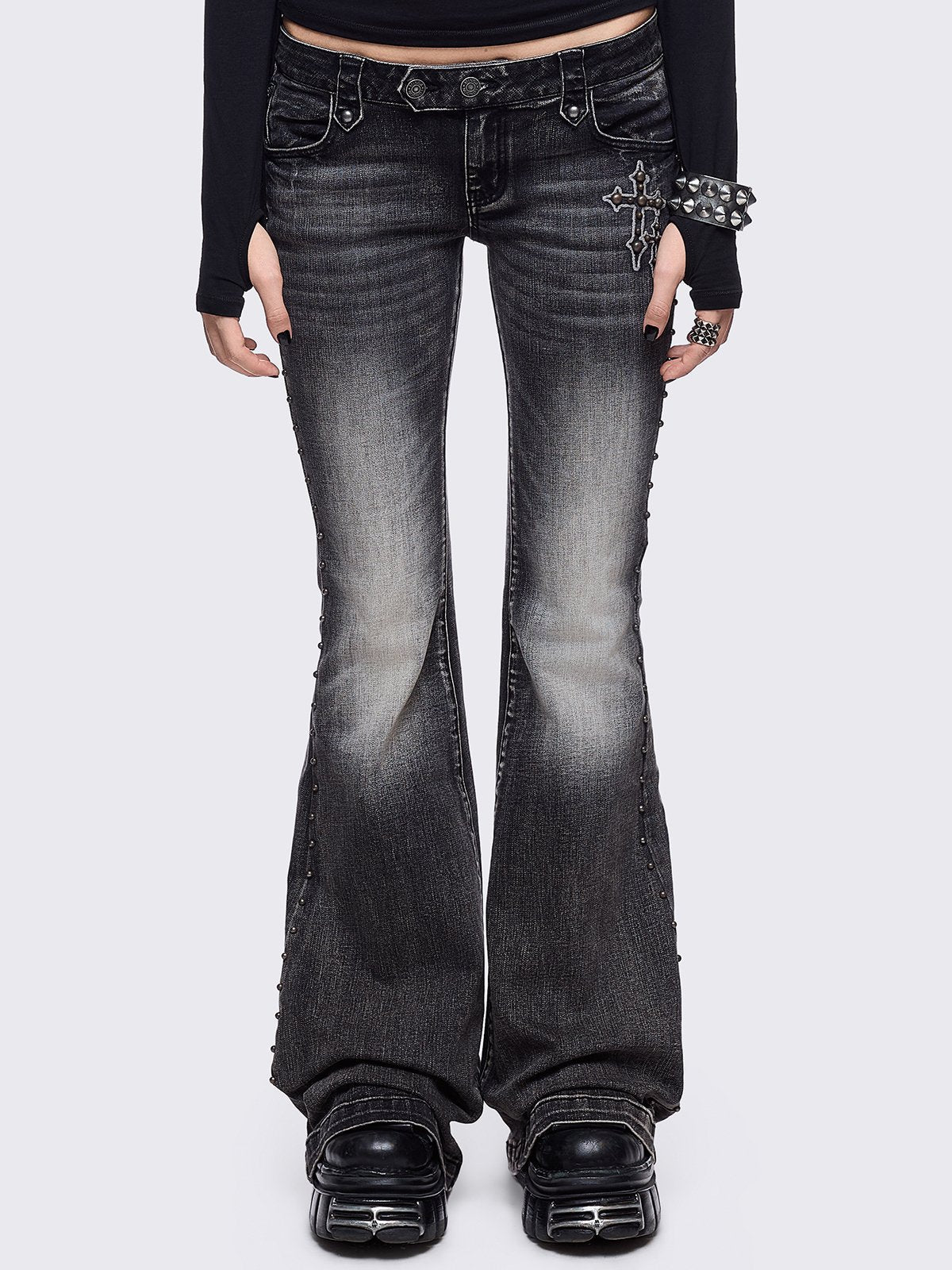 Black washed flared jeans featuring wings back and cross front embroideries and stud trim and details