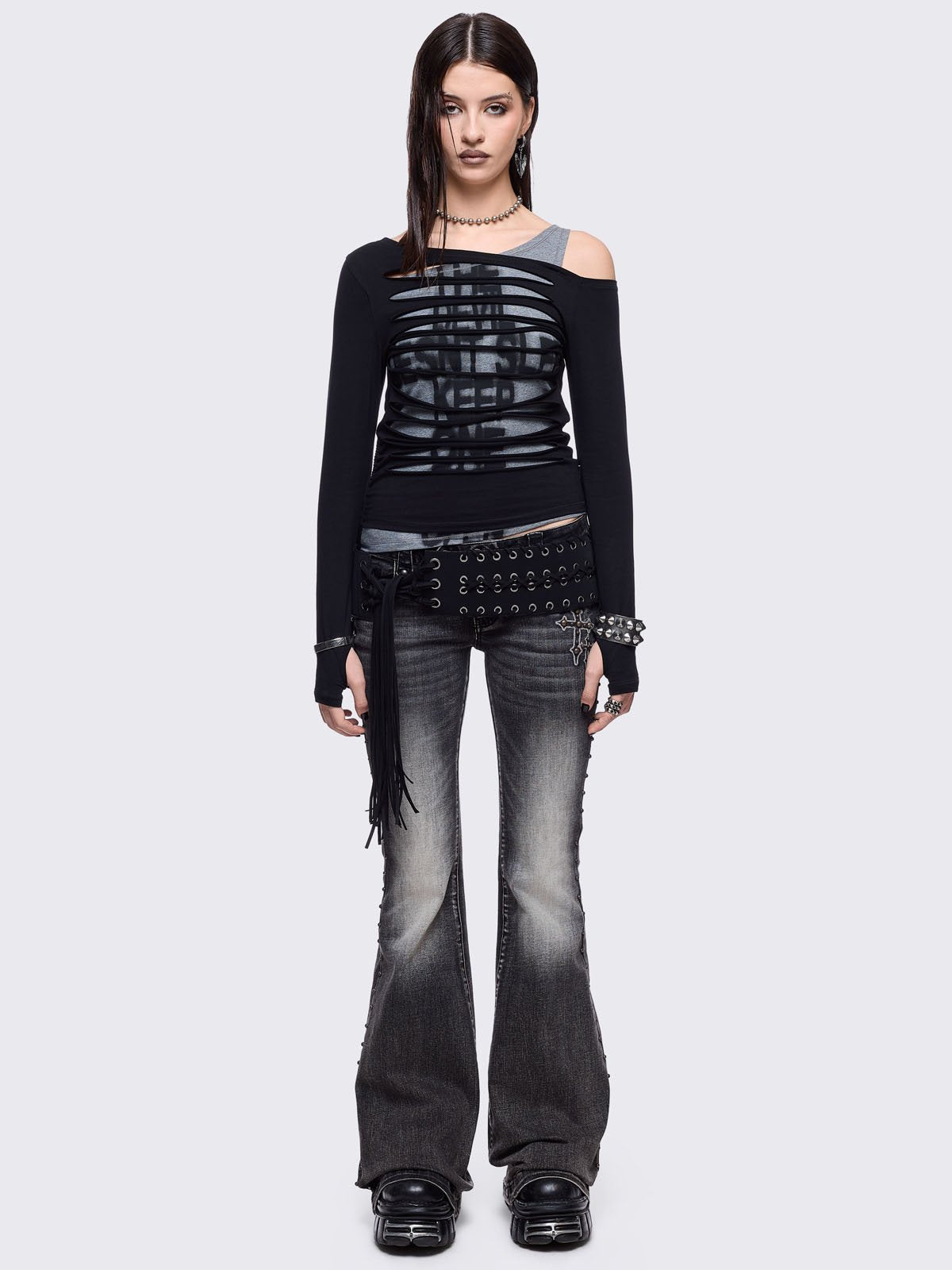 Black washed flared jeans featuring wings back and cross front embroideries and stud trim and details