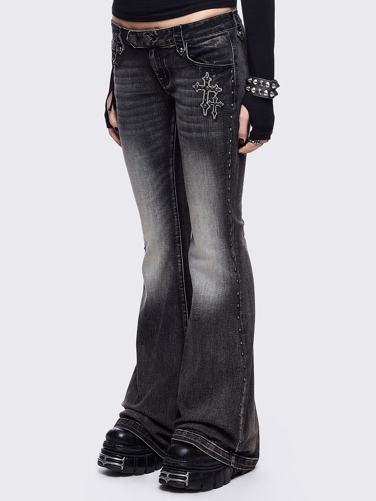 Black washed flared jeans featuring wings back and cross front embroideries and stud trim and details