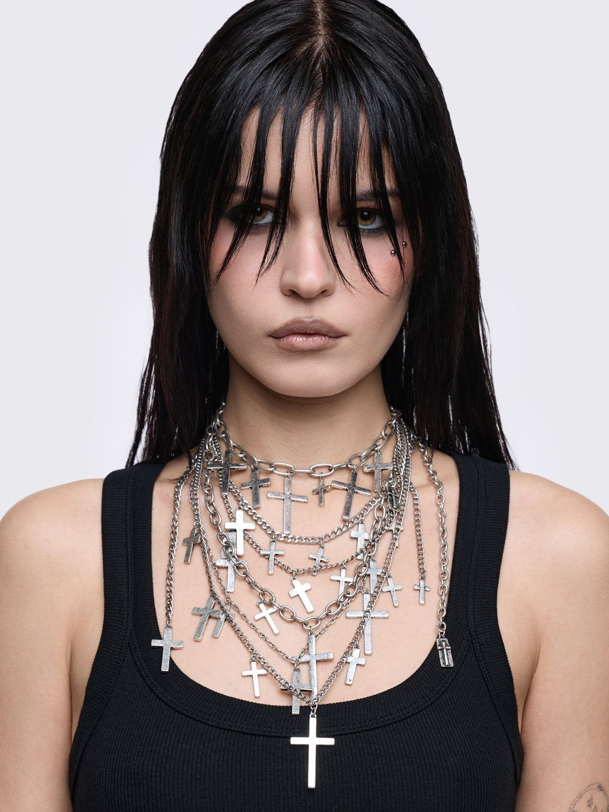 Silver multi-layered chain necklace with cross pendants.