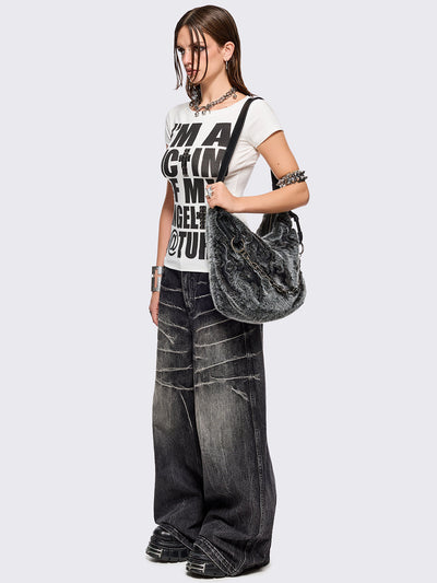 Black and grey faux fur shoulder bag with sigilism patches and silver chain detail.