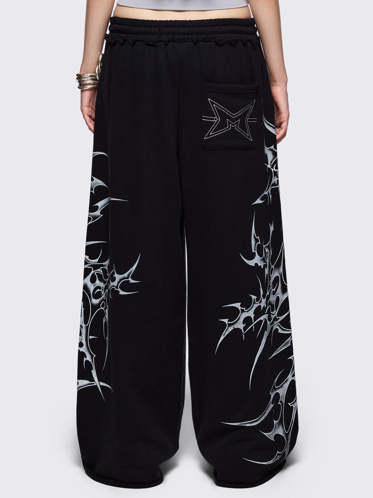 Black wide leg sweatpants with off-white sigilism graphic side print.