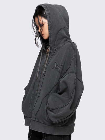 Washed grey oversized zip-up hoodie with exposed seam detailing, embroidered star patch on the chest, drawstring hood and ribbed cuffs and hem.