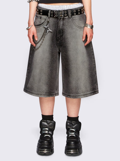 Black washed longline denim jorts featuring a grey overdye, removable chain, wide-leg fit and knee-length cut.