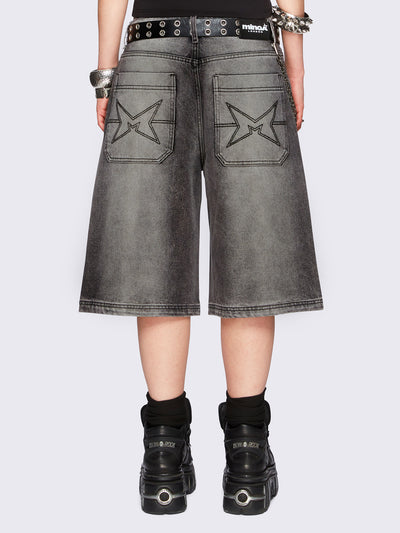 Black washed longline denim jorts featuring a grey overdye, removable chain, wide-leg fit and knee-length cut.