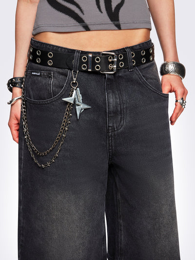 Black washed longline denim jorts with removable chain and wide-leg fit and knee-length cut.