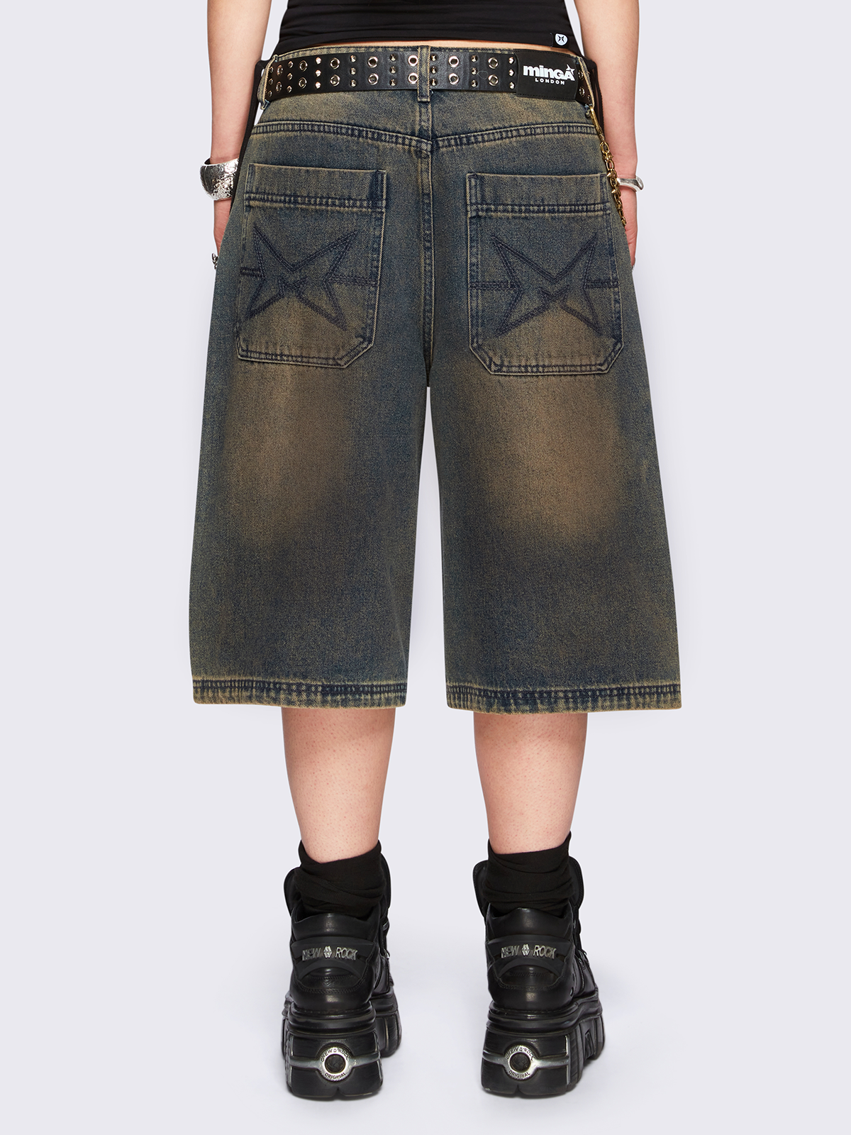 Blue washed longline denim jorts featuring a green overdye, removable chain, wide-leg fit and knee-length cut.