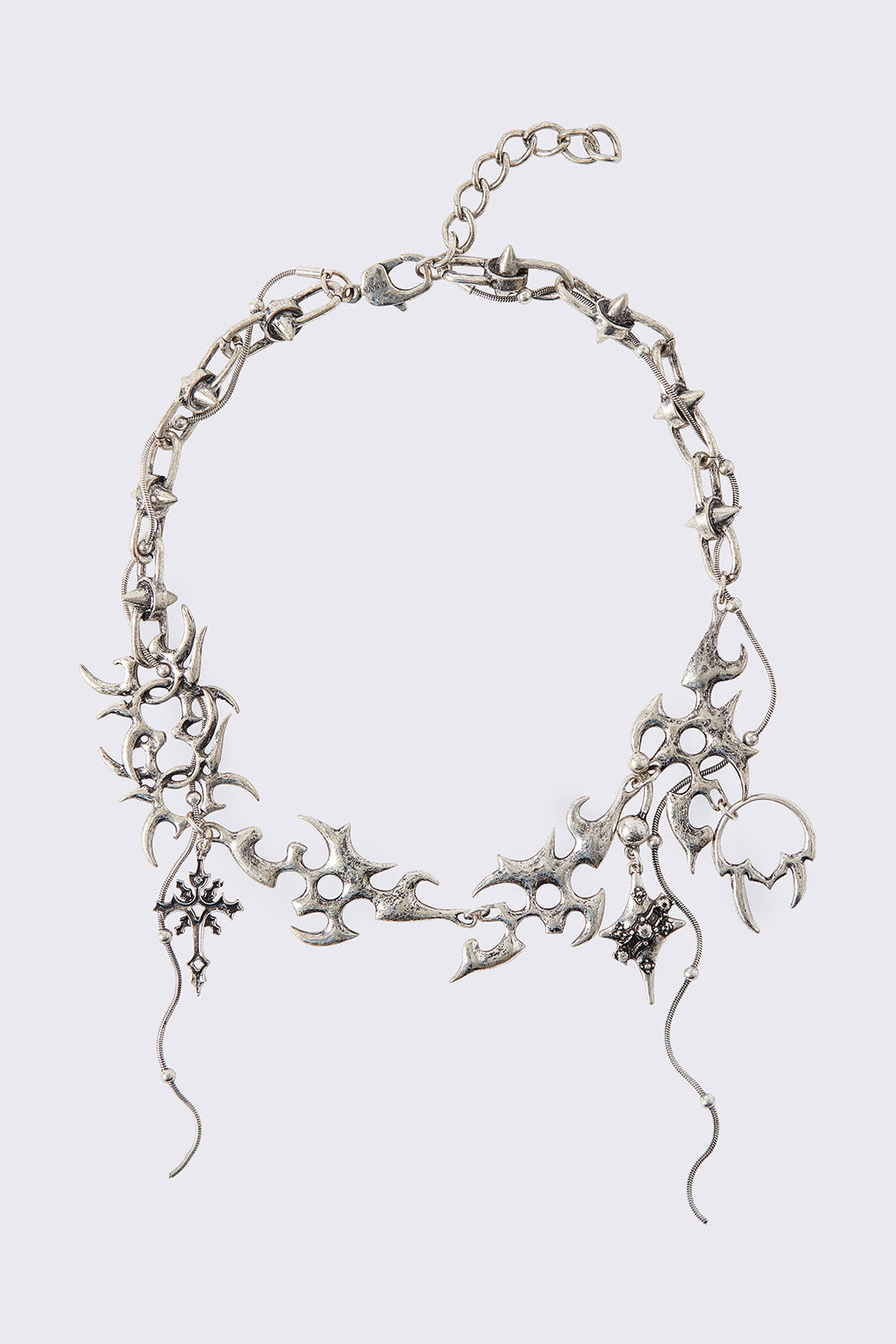 Chunky charm necklace with sigil-style details, cross charms and draped chain pendants.