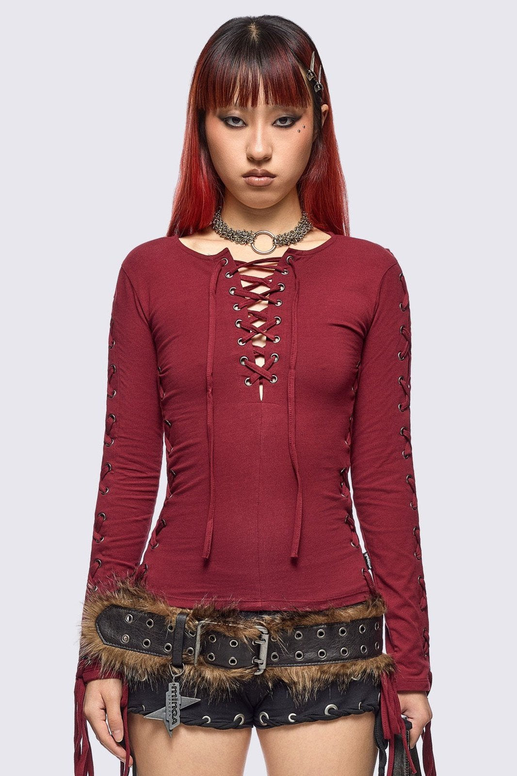 Burgundy long sleeve top with lace-up details.