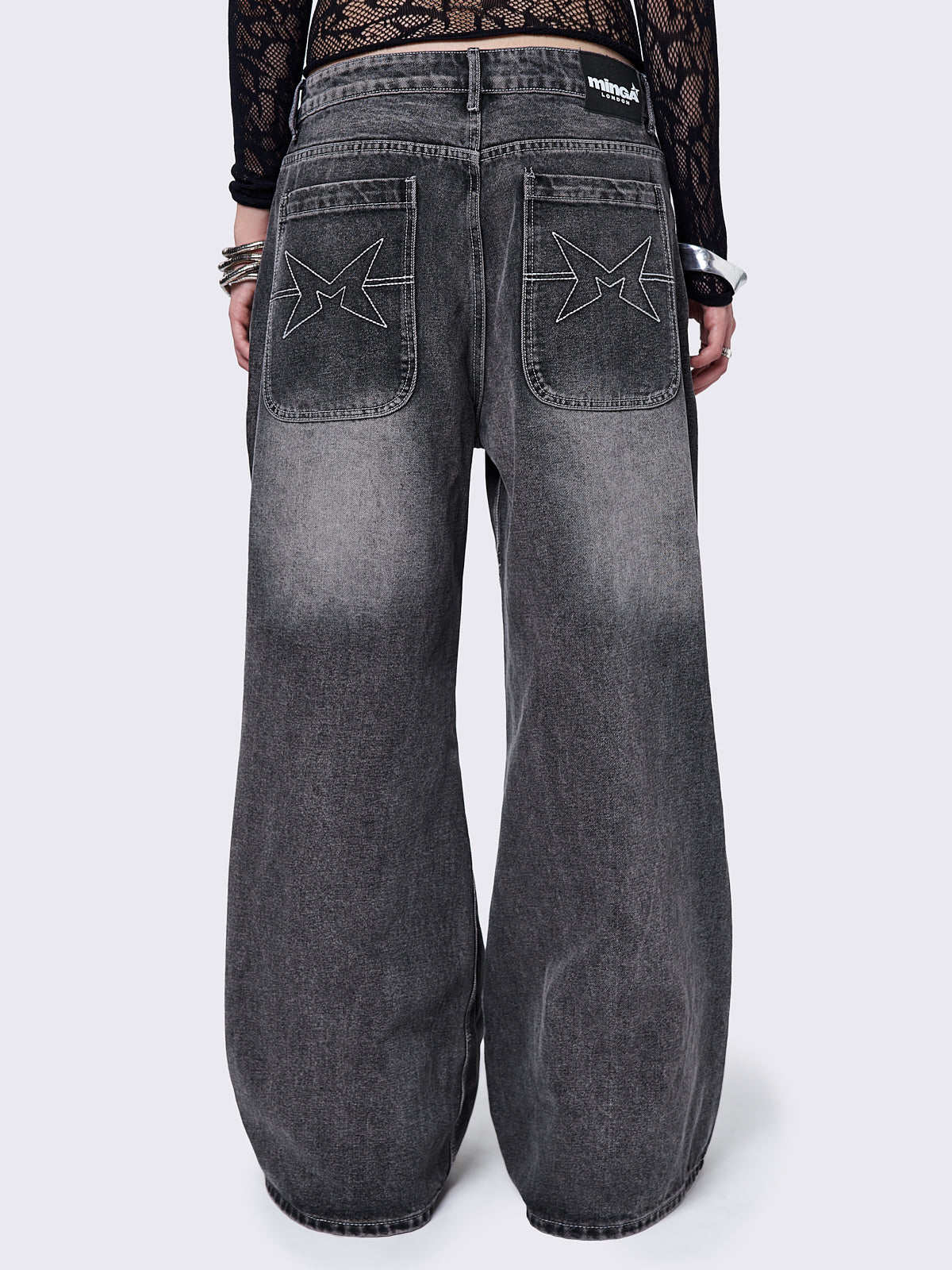 Black washed baggy jeans with grey overdye and cross panels and seams details. 