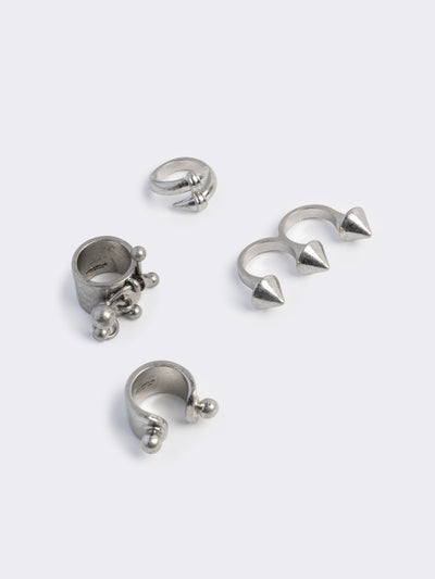 Set of 4 silver rings featuring piercing and spike designs
