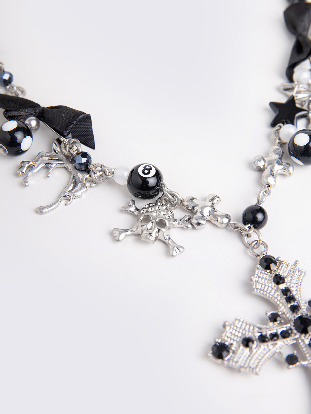 Black beaded necklace with cross pendant and more detail