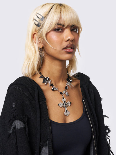 Black beaded necklace with cross pendant and more detail