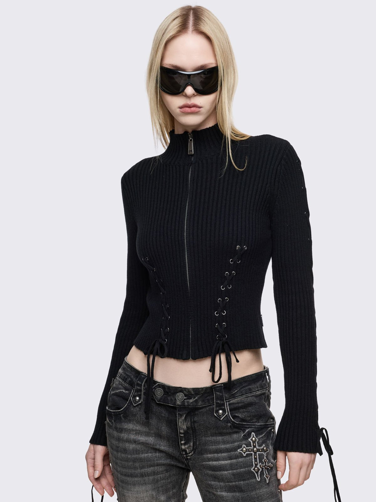 Black zip up cardigan with lace-up corset details. 