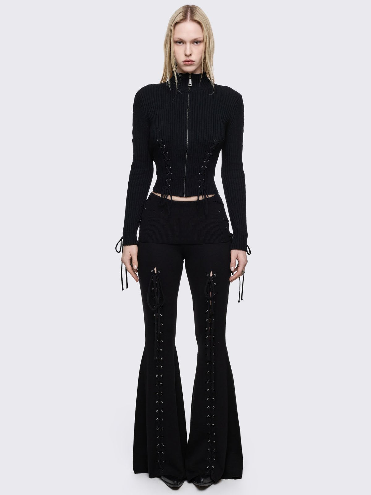 Black flare pants with front open lace-up corset details. 